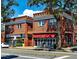 Commercial building with awnings and brick facade, street view featuring storefronts and pedestrian activity at 2034 Dahlia St # 1, Denver, CO 80207