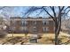 Brick apartment building with a manicured lawn and a walkway leading to the front entrance at 2034 Dahlia St # 1, Denver, CO 80207