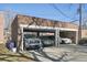 Open brick garage with three parking spaces and multiple cars parked at 2034 Dahlia St # 1, Denver, CO 80207