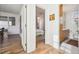 Hallway leading to bathroom and bedroom, featuring hardwood floors and neutral walls at 2034 Dahlia St # 1, Denver, CO 80207