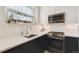 Modern kitchen featuring white cabinets, stainless steel appliances, and a bright window at 2034 Dahlia St # 1, Denver, CO 80207