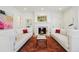 Bright living room with fireplace, white sofas with accent pillows and stylish area rug at 2034 Dahlia St # 1, Denver, CO 80207