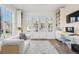 Bright living room with built-in bookshelves and french doors leading to the outdoors at 2034 Dahlia St # 1, Denver, CO 80207