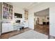 Bright home office with French doors, custom built-ins, and cozy seating with an area rug at 2034 Dahlia St # 1, Denver, CO 80207