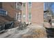 Outdoor patio with stone flooring, brick walls, wrought iron seating, and grill at 2034 Dahlia St # 1, Denver, CO 80207