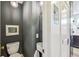 Contemporary powder room with stylish lighting, pedestal sink, and neutral wall color at 2034 Dahlia St # 1, Denver, CO 80207