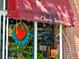 Close-up of restaurant's window sign, featuring eye-catching logo and seasonal decor at 2034 Dahlia St # 1, Denver, CO 80207