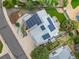 Aerial view of house featuring solar panels, manicured landscaping, and a backyard deck at 2777 W 106Th Cir, Denver, CO 80234