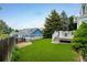 Expansive backyard featuring artificial turf, a deck, and well maintained landscape at 2777 W 106Th Cir, Denver, CO 80234