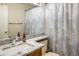 Bright bathroom with a marble countertop, decorative shower curtain, and updated fixtures at 2777 W 106Th Cir, Denver, CO 80234