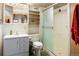 Bathroom featuring vanity, toilet, shelves, and shower with glass door at 2777 W 106Th Cir, Denver, CO 80234