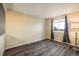 Bedroom showing hardwood floors and a large window with curtains at 2777 W 106Th Cir, Denver, CO 80234