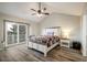 Bright bedroom with vaulted ceiling, white bed frame, and a sliding glass door to private balcony at 2777 W 106Th Cir, Denver, CO 80234