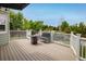 Inviting deck featuring wood flooring, a black steel bench, fire pit, and views of the backyard at 2777 W 106Th Cir, Denver, CO 80234