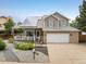 Charming two-story home with solar panels, covered porch, and meticulously landscaped front yard at 2777 W 106Th Cir, Denver, CO 80234