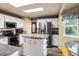 Kitchen with stainless steel appliances, white cabinets, granite countertops, and a kitchen island at 2777 W 106Th Cir, Denver, CO 80234