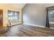 Minimalist living room with wood flooring, natural light from windows, and neutral wall colors at 2777 W 106Th Cir, Denver, CO 80234