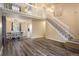 Open-concept living space with high ceilings, hardwood floors, and staircase to the second level at 2777 W 106Th Cir, Denver, CO 80234