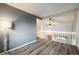 Upstairs living room with wood floor and white banister at 2777 W 106Th Cir, Denver, CO 80234