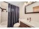 Bathroom featuring a shower over tub and a single vanity at 7875 Cyd Dr, Denver, CO 80221