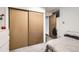Bedroom with gray carpet and closet with sliding doors at 7875 Cyd Dr, Denver, CO 80221