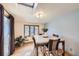 Dining room featuring a skylight, hardwood floors, and a view of the backyard at 7875 Cyd Dr, Denver, CO 80221