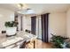 Sunlit dining area with skylight, hardwood floors, and sliding glass door at 7875 Cyd Dr, Denver, CO 80221