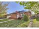 Cozy brick home with a neatly manicured lawn, complemented by a small front porch at 7875 Cyd Dr, Denver, CO 80221