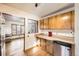 A kitchen with stainless steel appliances, wooden cabinets, and hardwood floors at 7875 Cyd Dr, Denver, CO 80221