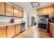 Efficient kitchen layout with stainless steel appliances and hardwood floors, adjacent to dining area at 7875 Cyd Dr, Denver, CO 80221