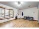 Spacious living room with bright hardwood floors and a large window at 7875 Cyd Dr, Denver, CO 80221