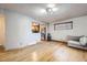 Bright living room featuring hardwood floors, with a view into the kitchen at 7875 Cyd Dr, Denver, CO 80221