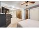 Spacious main bedroom featuring carpeted floors, ceiling fan and ample closet space at 7875 Cyd Dr, Denver, CO 80221