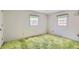 Bright bedroom with green carpet, two windows, white walls and a closet at 3825 S Peach Way, Denver, CO 80237