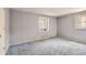 Light blue bedroom with textured wallpaper, carpeted floors, and window seat at 3825 S Peach Way, Denver, CO 80237