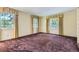 Bright bedroom featuring neutral carpet, natural light from two windows and yellow colored curtains at 3825 S Peach Way, Denver, CO 80237