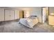 Large carpeted bedroom with sizable closet space and adjacent doorway to the bathroom at 3825 S Peach Way, Denver, CO 80237