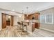 Finished basement with a bar area featuring granite countertops, cabinetry, and barn door entry at 19382 Dunraven St, Parker, CO 80134