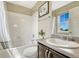 Bright bathroom with a shower/tub combo, modern vanity, and neutral color scheme at 19382 Dunraven St, Parker, CO 80134