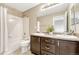 Neutral toned bathroom featuring double vanity, bath tub with white tiling, and modern fixtures at 19382 Dunraven St, Parker, CO 80134