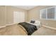 Minimalist bedroom features carpet, closet, and window for natural light at 19382 Dunraven St, Parker, CO 80134