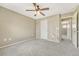 Bedroom with a mural, neutral walls, carpeted floors, and adjoining room access at 19382 Dunraven St, Parker, CO 80134