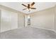 Empty bedroom with neutral walls, carpeted floors, and a double door closet at 19382 Dunraven St, Parker, CO 80134