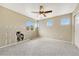 Spacious bedroom with neutral walls, carpeted floors, and natural light from multiple windows at 19382 Dunraven St, Parker, CO 80134