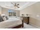 Bedroom featuring a tray ceiling, plush carpet, and a view of the outdoors at 19382 Dunraven St, Parker, CO 80134