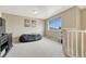 Bonus room featuring neutral carpet, ample natural light, and ski resort art at 19382 Dunraven St, Parker, CO 80134