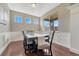 Formal dining room featuring wainscotting, hardwood floors, large windows, and a stylish table setting at 19382 Dunraven St, Parker, CO 80134