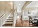 Inviting entryway with hardwood floors, staircase, wainscotting, and arched openings, leading to a bright and open floor plan at 19382 Dunraven St, Parker, CO 80134