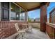 Charming front porch with brick accents, offering a welcoming outdoor seating area at 19382 Dunraven St, Parker, CO 80134