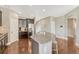 Bright kitchen featuring granite island with seating, stainless steel appliances, and hardwood floors at 19382 Dunraven St, Parker, CO 80134